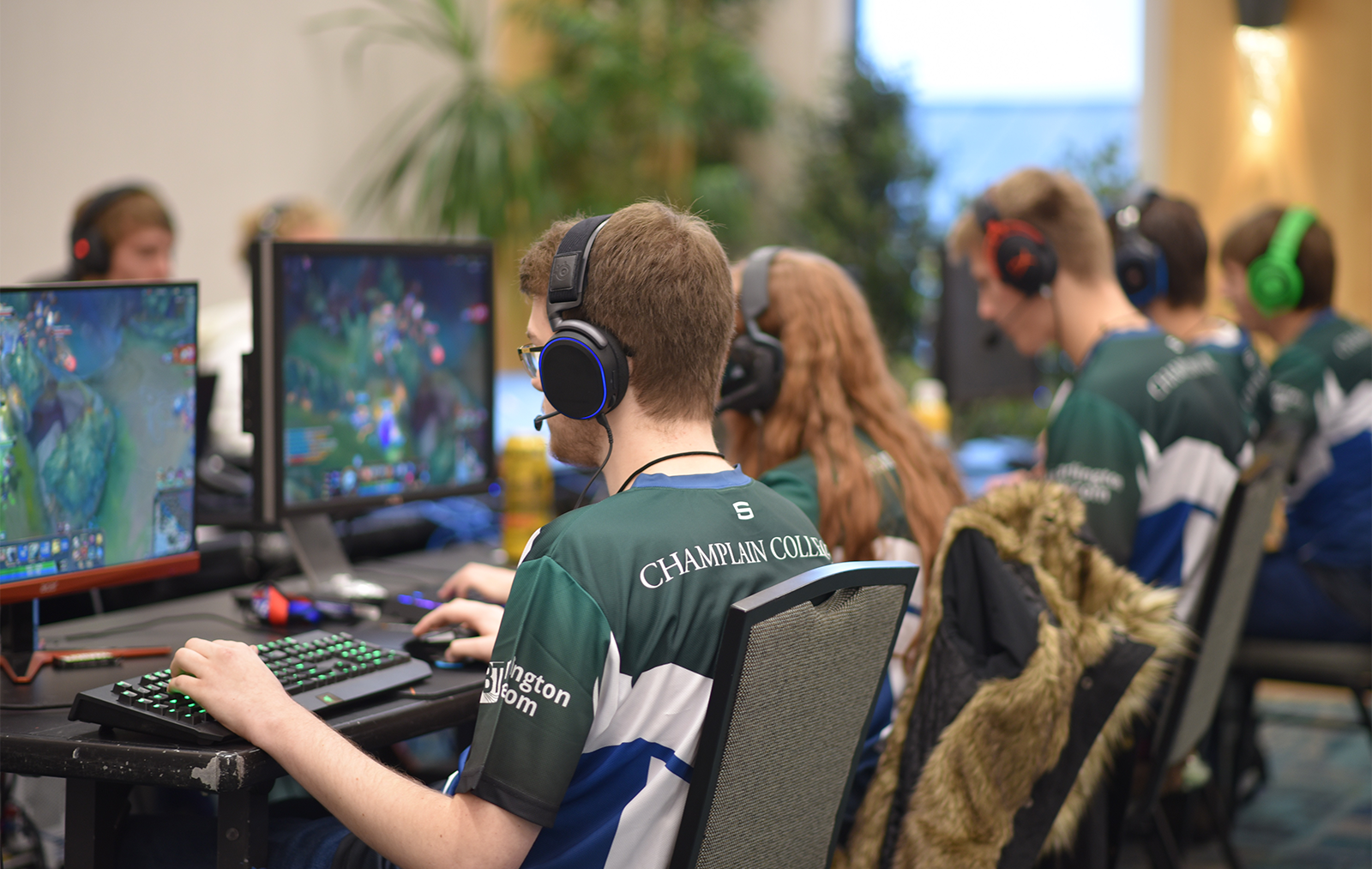 Group of students wearing team uniforms playing Esports games